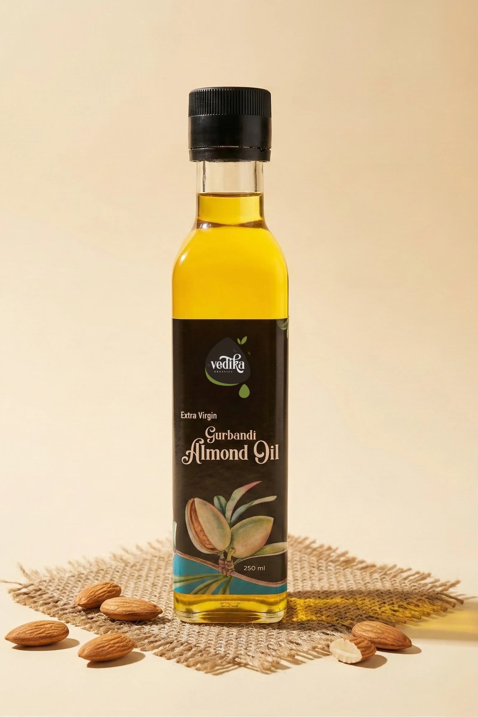 Bottle of almond oil with almonds on a textured surface